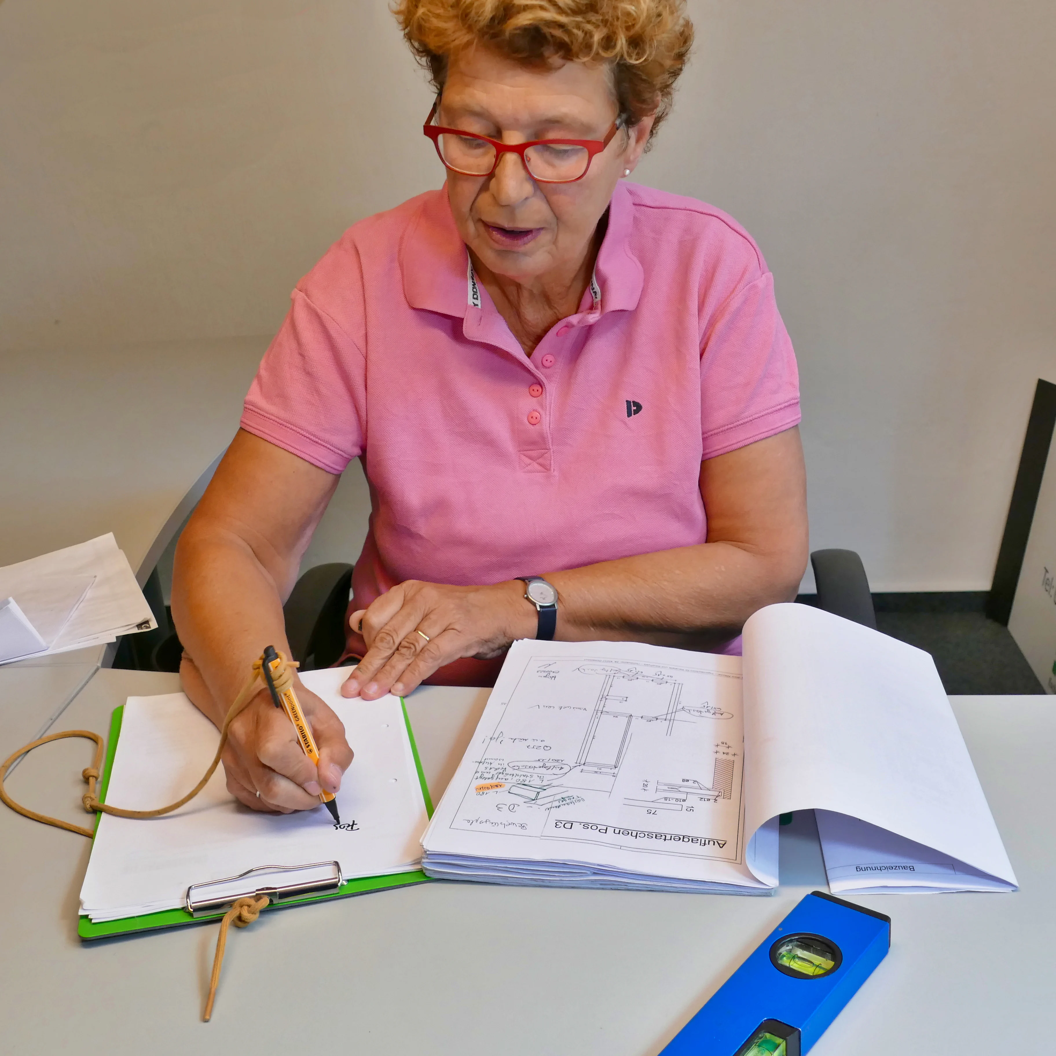 A woman fills in construction documents